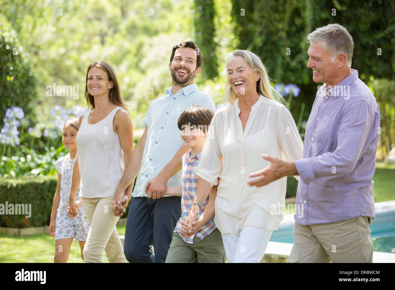 Multi-generation family walking in backyard Banque D'Images Multi-generation family walking in backyard Banque D'Images