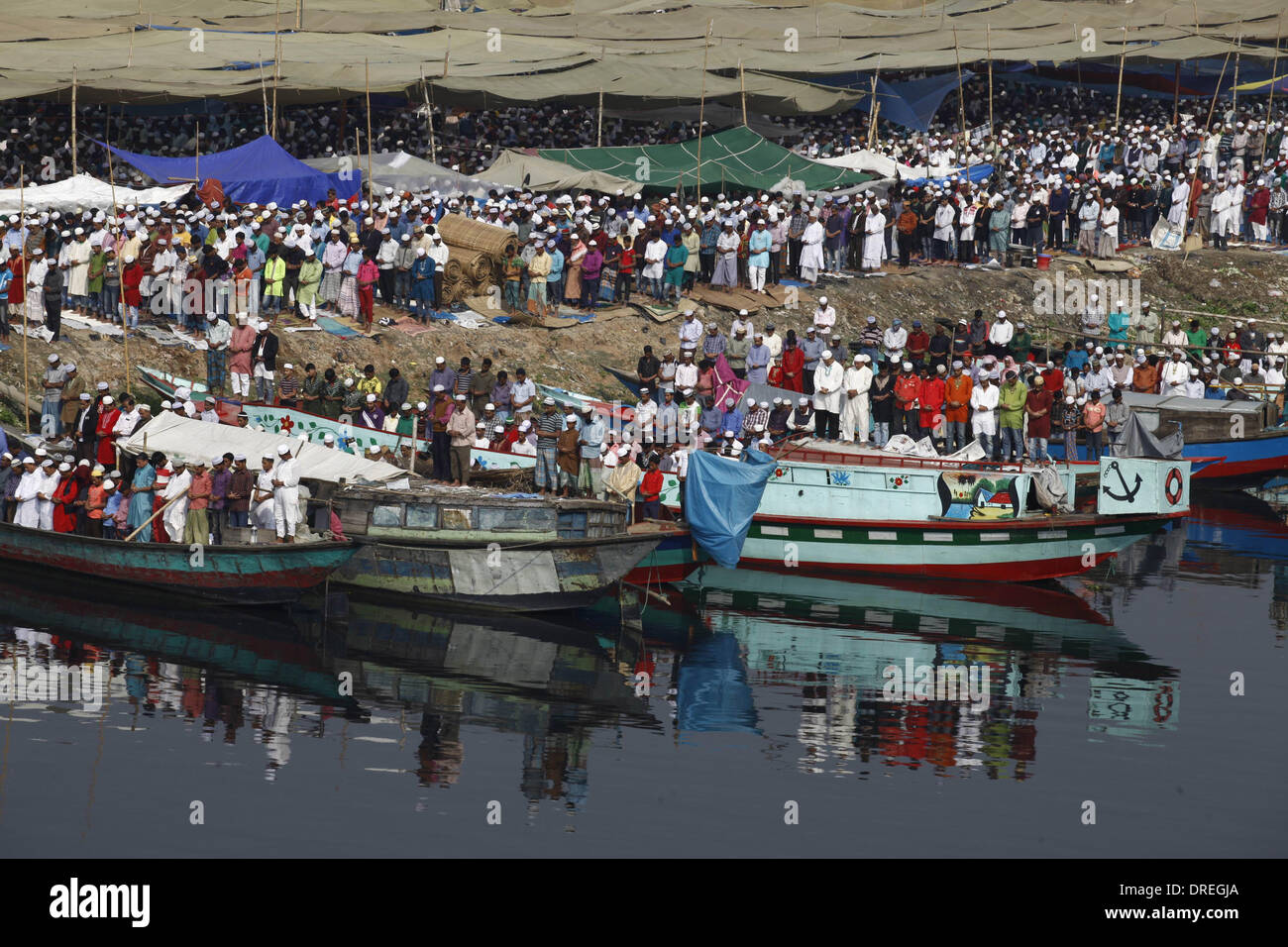 Dhaka, Bangladesh 24 Janvier 2014;des milliers de Musulmans assistent à la prière Jummas sur les rives de la rivière Turag au cours de la première journée des trois jours Congrégation musulmane. Au moins deux millions de dévots de la maison et à l'étranger se sont réunis à la masse de la prière d'y participer. La première phase d'Ijtema est prêt à démarrer, comme ceux qui viennent au Bangladesh pour Ijtema, la deuxième plus grande congrégation musulmane après l'Hadj, sont accueillis avec prêt pour leur pèlerinage à la rivière Turag banque. Zakir Hossain Chowdhury Crédit : zakir/Alamy Live News Banque D'Images