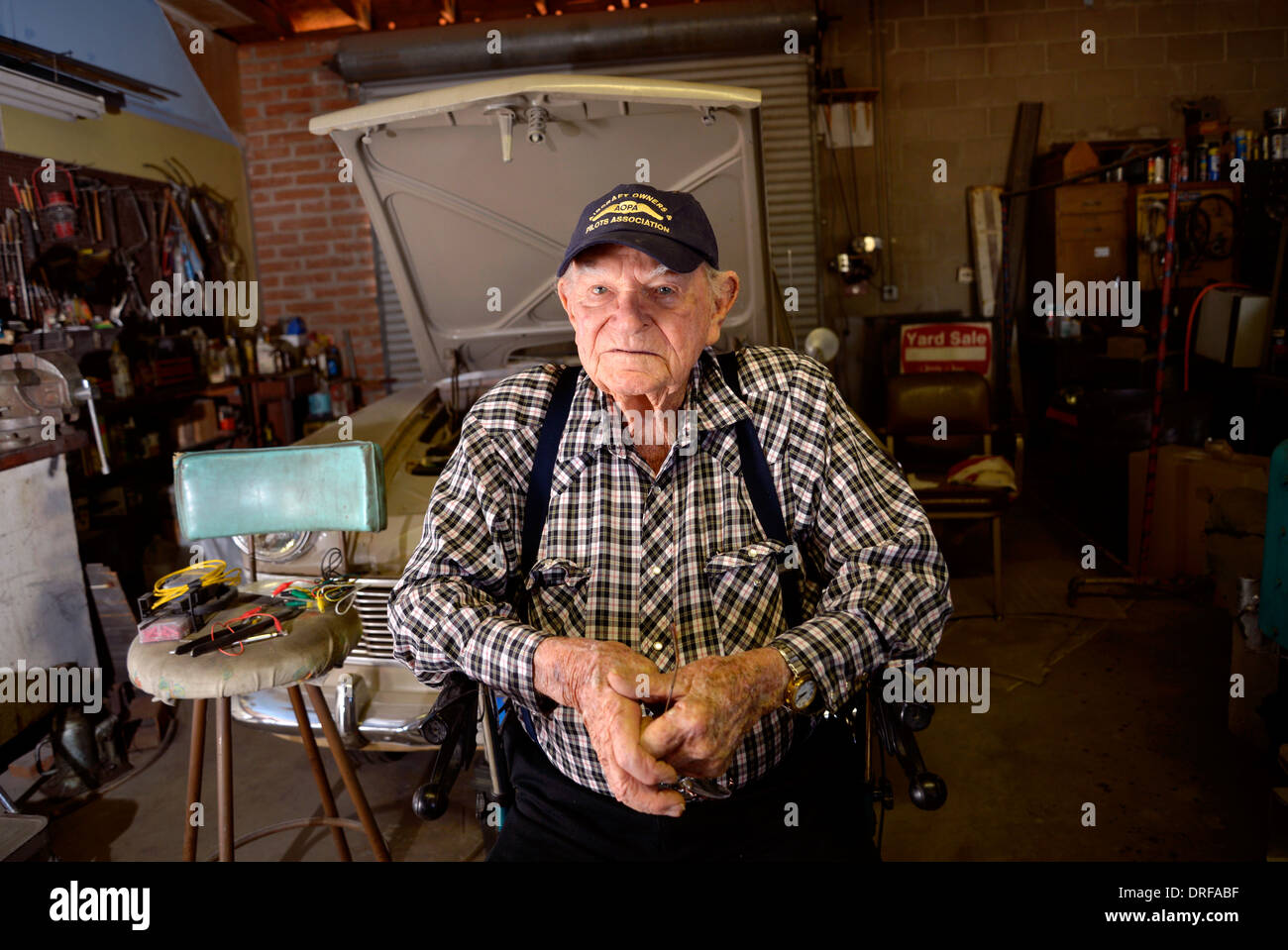 A 93 ans, l'homme dans son garage, où il travaille sur les voitures. Banque D'Images