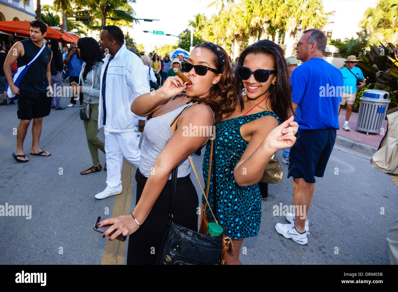 Miami Beach Florida,Ocean Drive,week-end art déco,festival,Street fair,hispanique Black African Africains,femme femme femme,jeune,cigare,pose,amis,su Banque D'Images