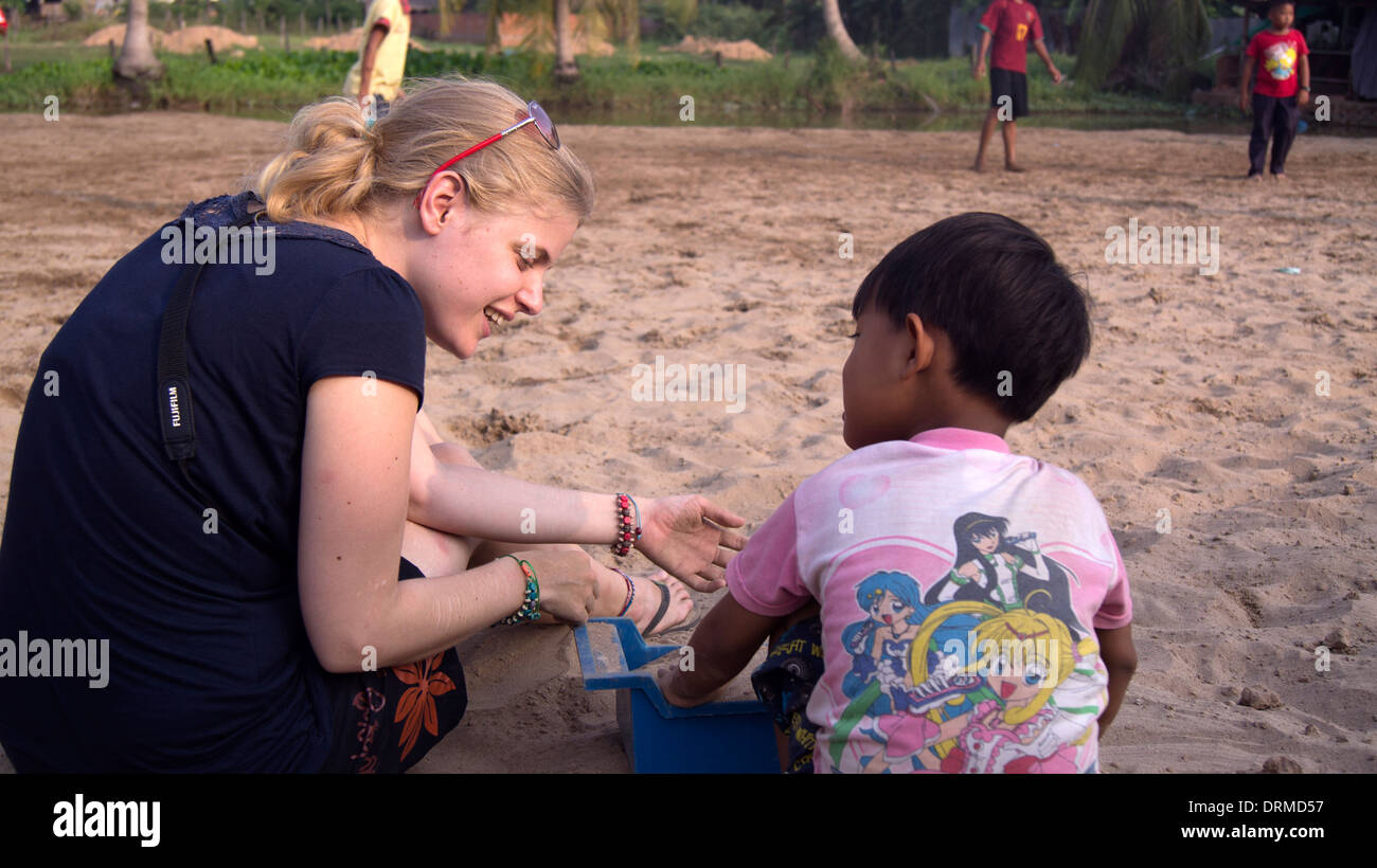 Travailleur de l'aide des femmes avec enfant Phnom Penh Cambodge Asie du sud-est Banque D'Images