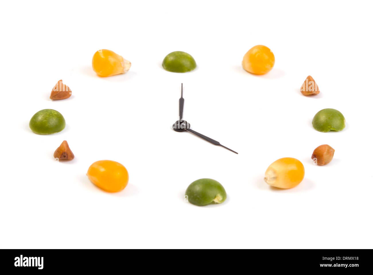 Fruit sous la forme d'heures isolées sur fond blanc Banque D'Images
