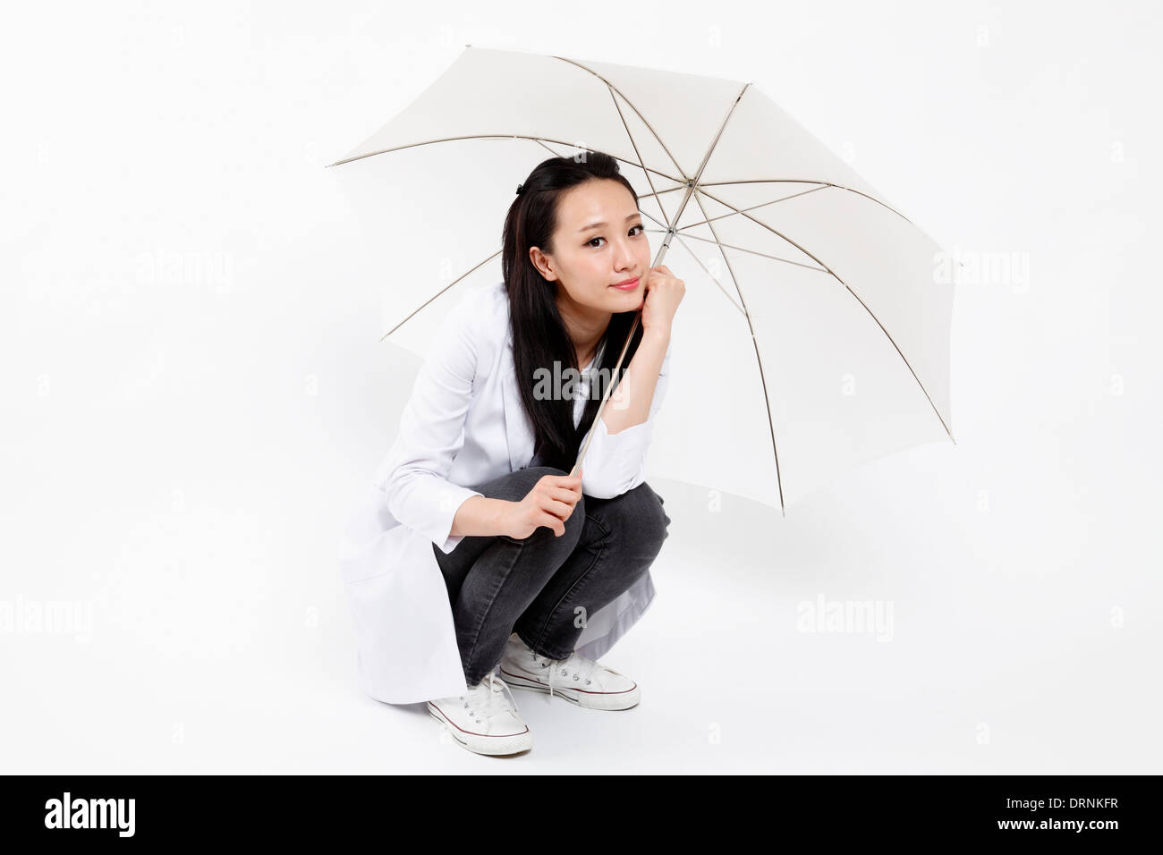 Femme médecin prend parapluie blanc pour portrait. Banque D'Images