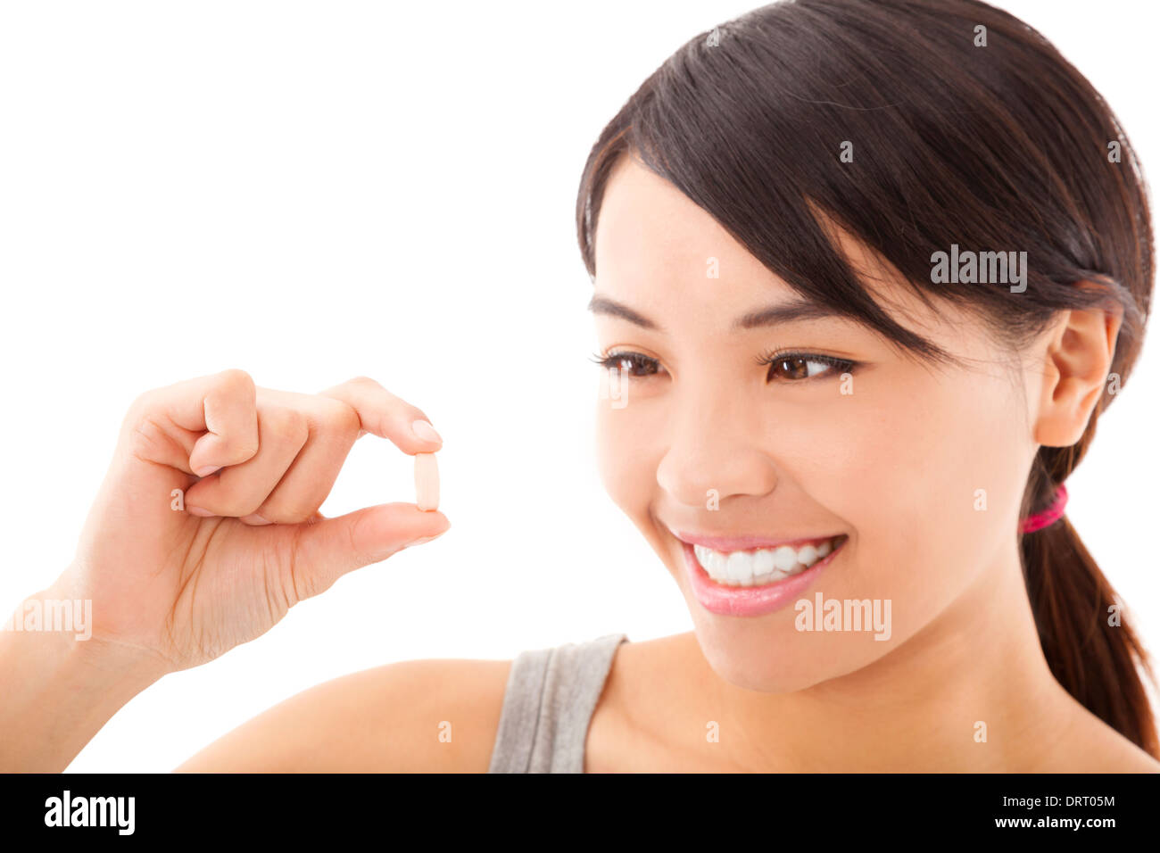 Portrait of young happy smiling woman showing vitamine Banque D'Images