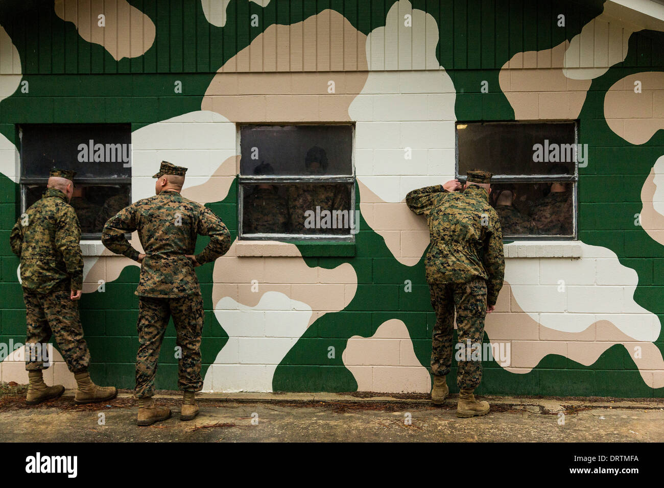 Les instructeurs de l'US Marine percer si le pic des fenêtres de la chambre à gaz regarder recrute au cours de boot camp, le 13 janvier 2014 à Parris Island, SC. Banque D'Images