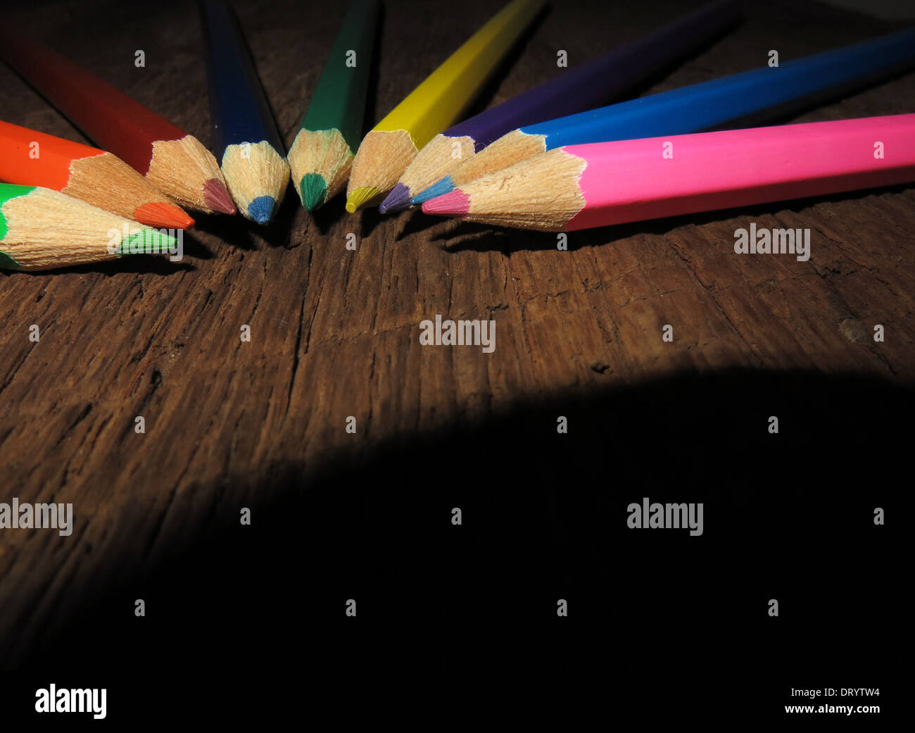 Crayons de couleur sur planche de bois. Banque D'Images