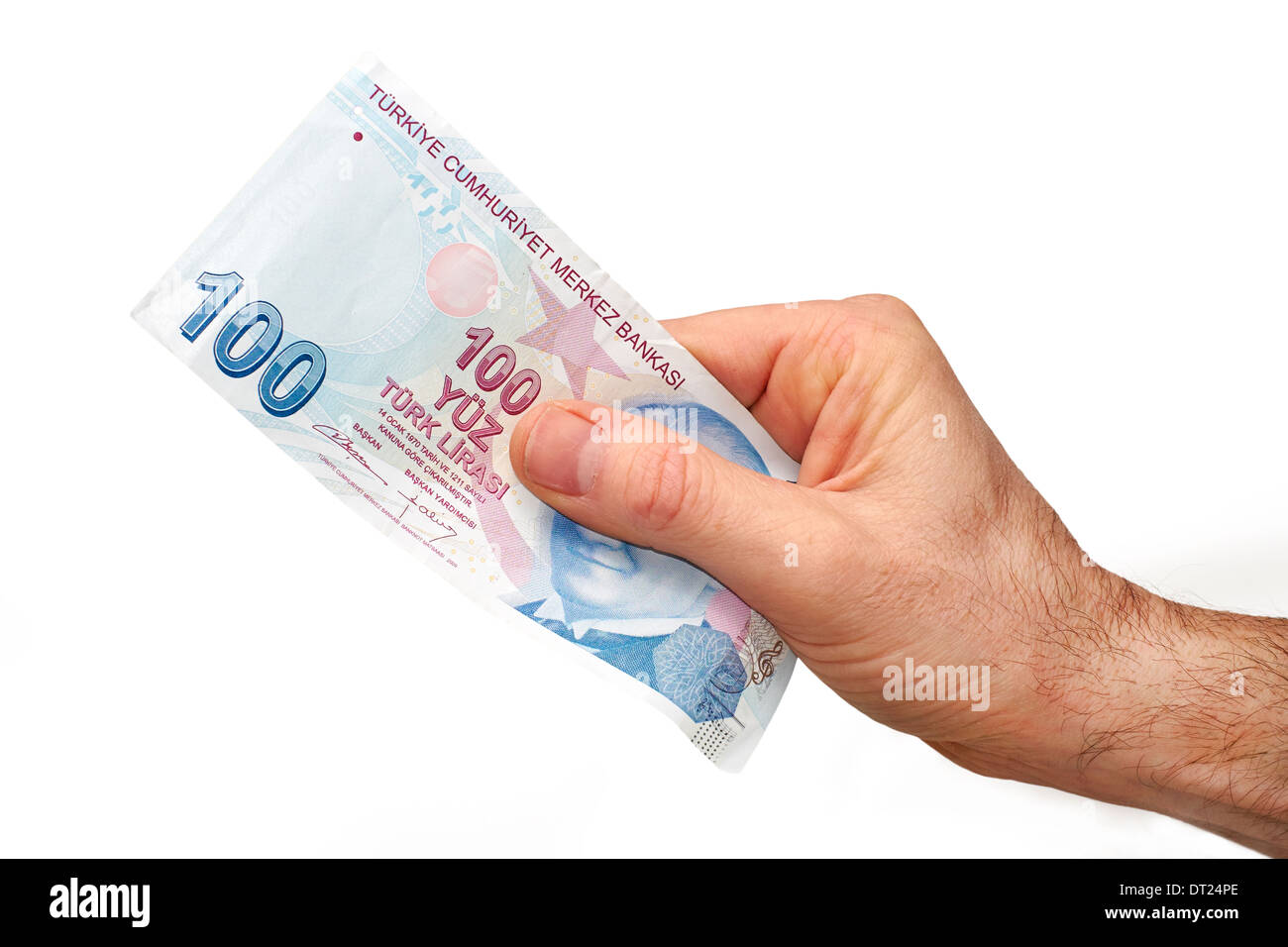 Une main tenant un livre 100 turc remarque, sur un fond blanc. Banque D'Images