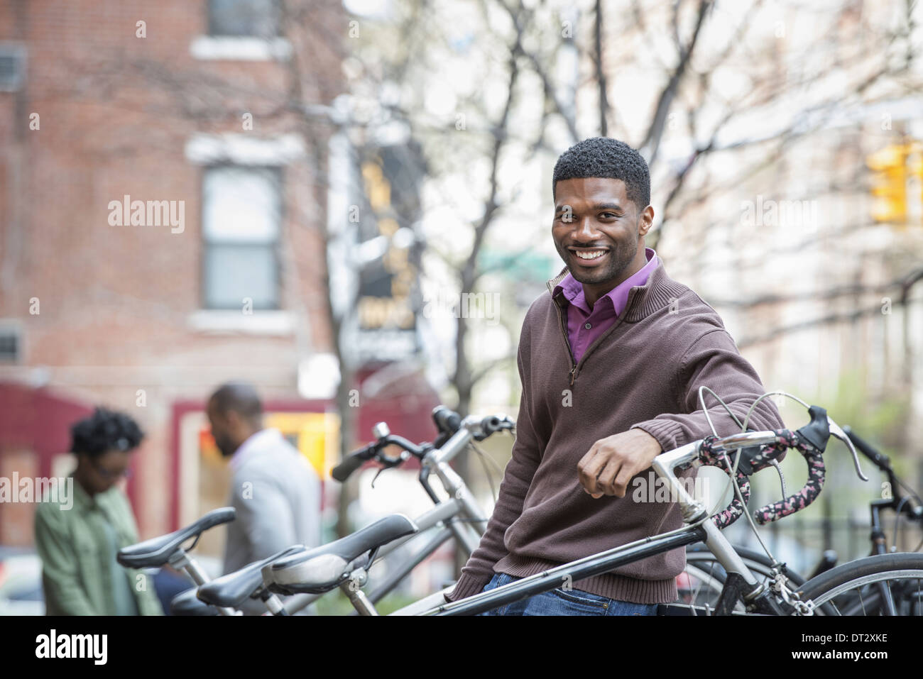 Un jeune homme souriant à l'appareil photo porte-vélo Banque D'Images