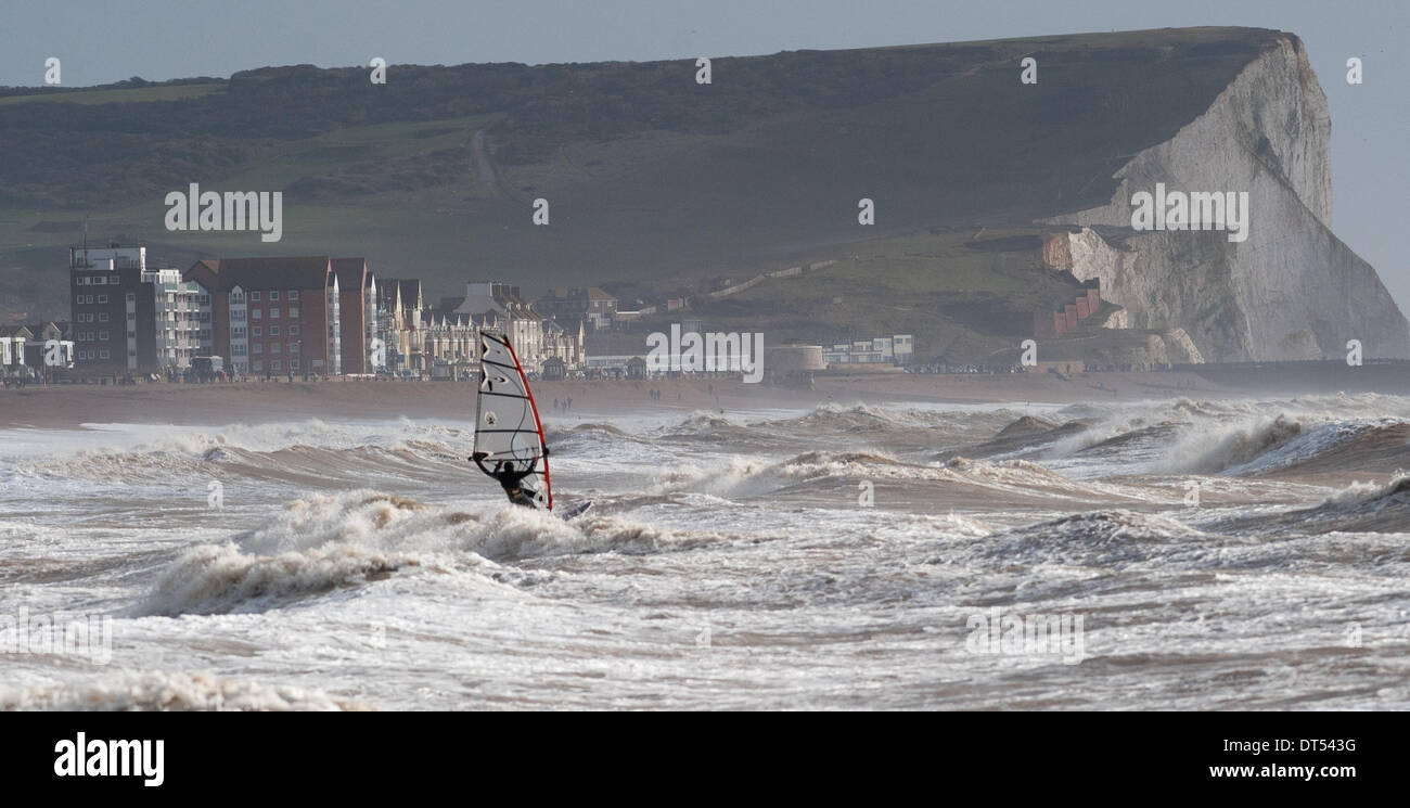 Un windsurfer batailles contre les vagues au large de Tide Mills beach Newhaven aujourd'hui que les tempêtes continuent de battre la côte sud de la Grande-Bretagne . Seaford Head falaises peut être vu dans la distance Banque D'Images