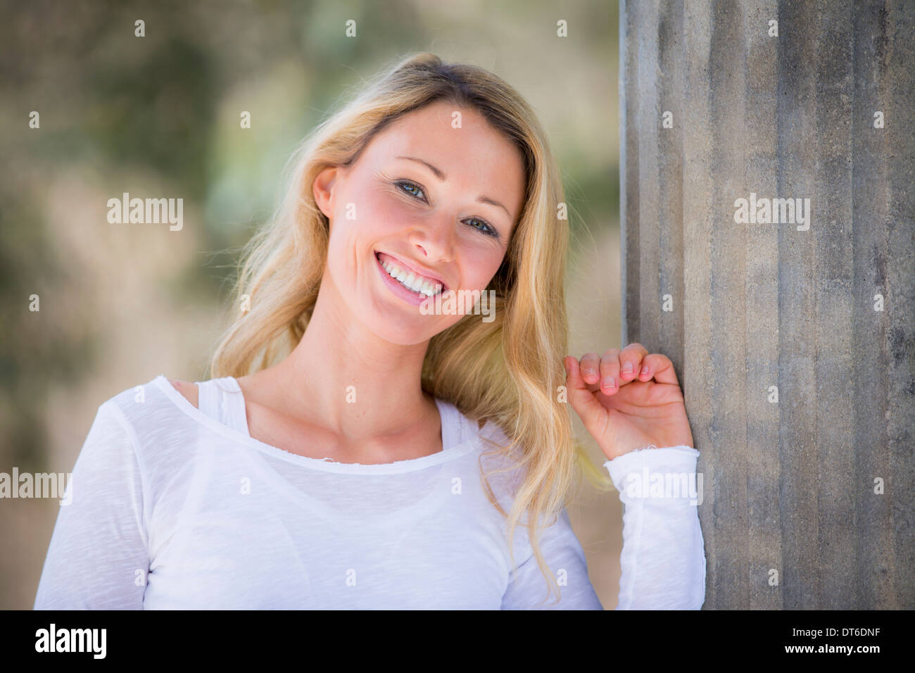 Portrait of blond woman wearing white top Banque D'Images