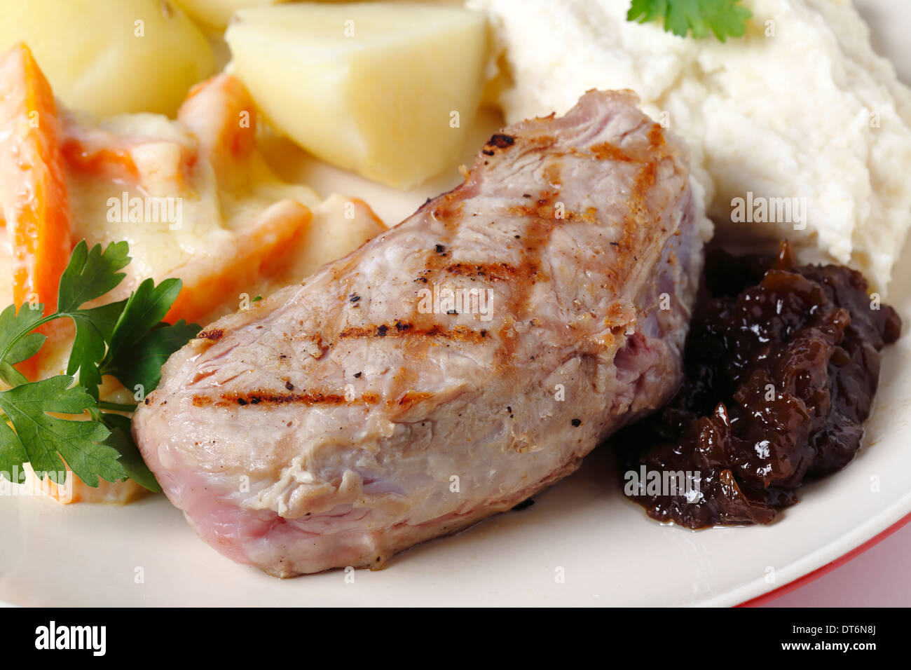 Steak de surlonge de veau avec confiture d'oignons, purée de céleri-rave, la julienne de carottes dans une sauce blanche et des pommes de terre, Banque D'Images