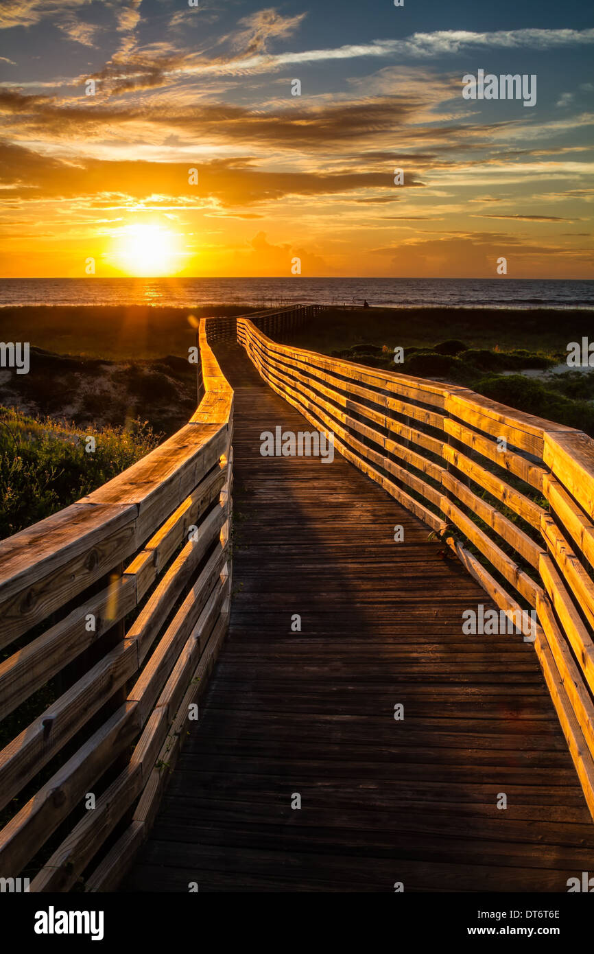 Un soleil boardwalk menant à l'aube sur la plage. Amelia Island, Floride. Banque D'Images