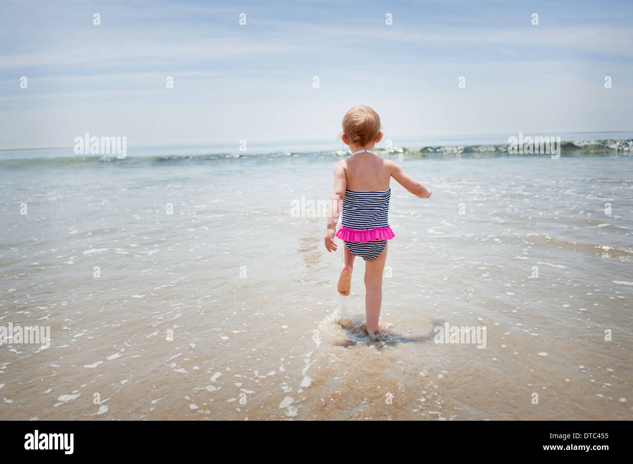 Female toddler tournant dans la mer Banque D'Images
