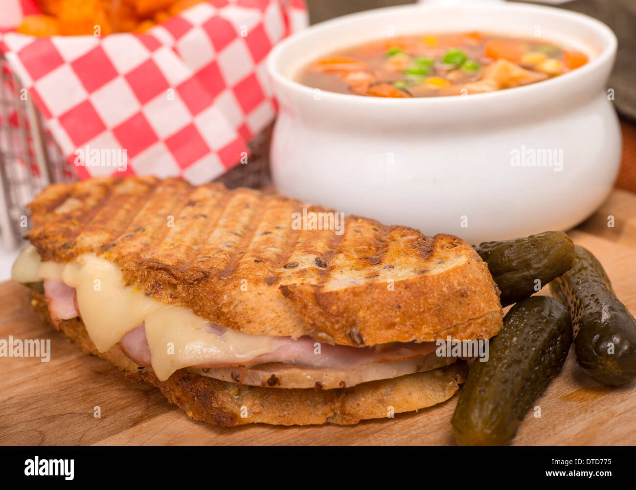 Jambon de porc frais, fromage suisse et panini servi avec légumes et pommes de terre frites. Banque D'Images