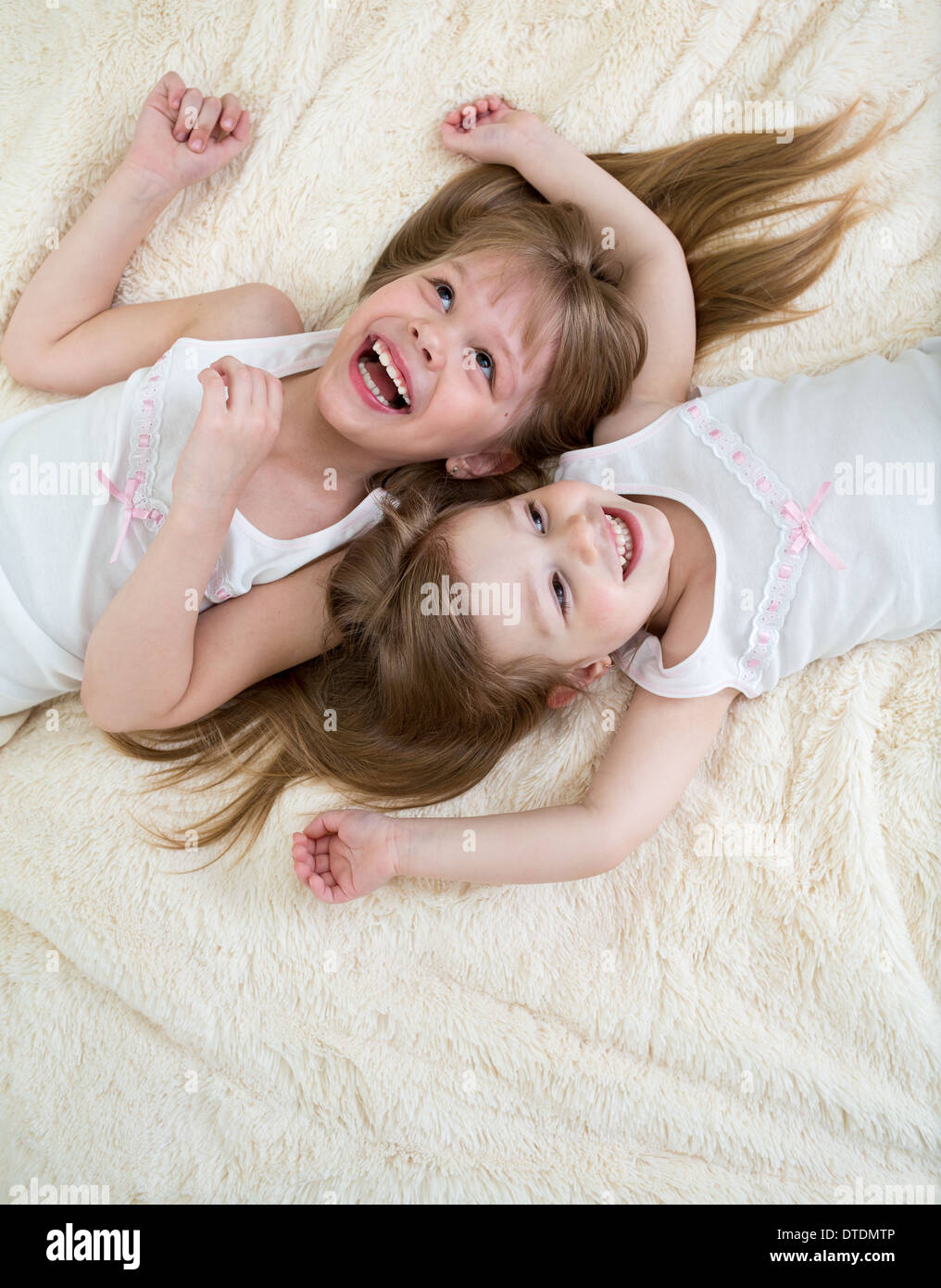 Happy little girls lying on retour vue d'en haut Banque D'Images