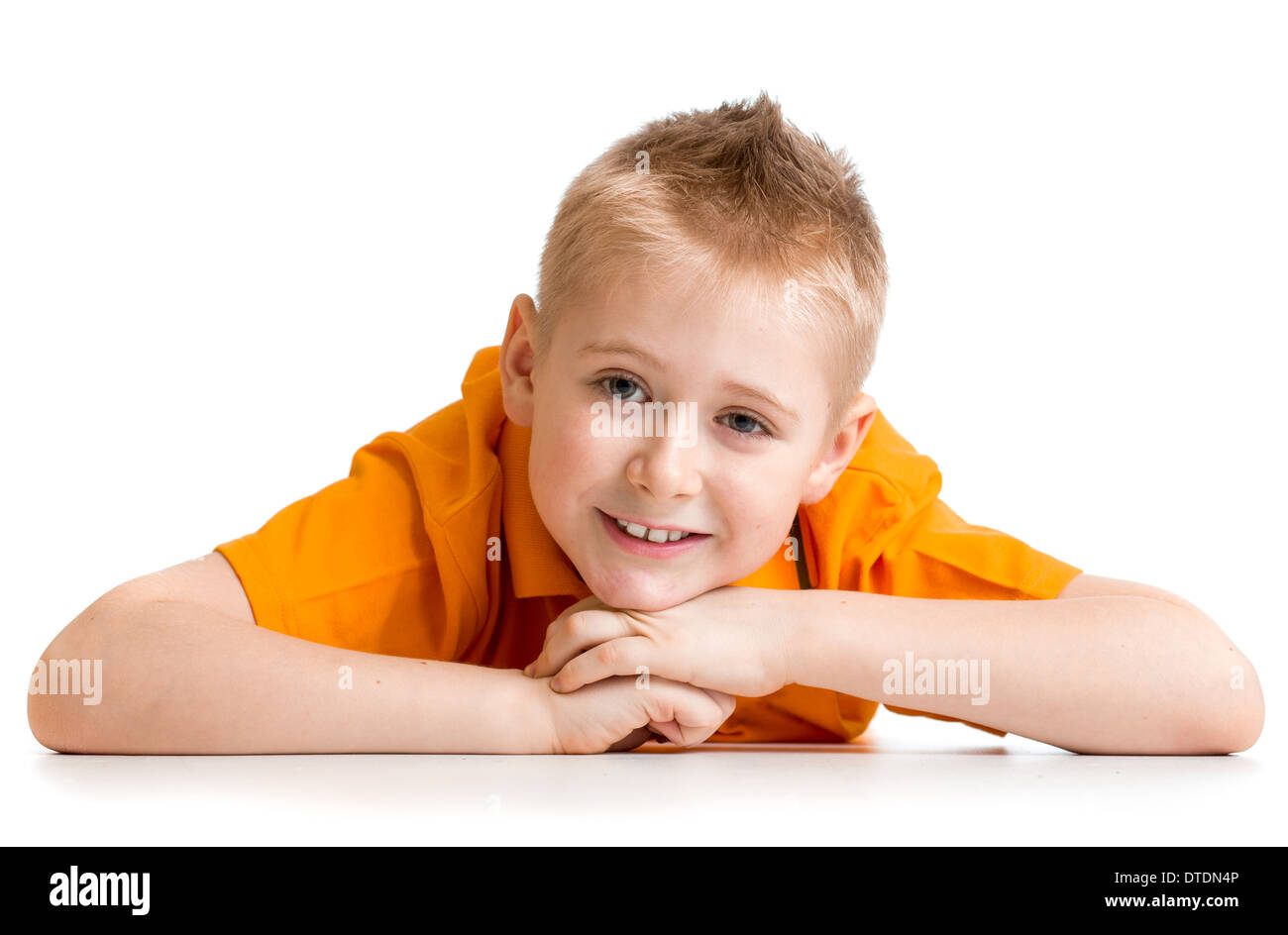 Smiling boy lying on floor isolated on white Banque D'Images
