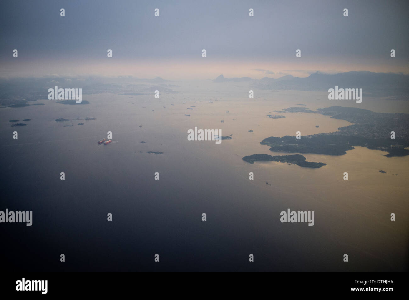 Vue aérienne du trafic maritime intense dans la baie de Guanabara, Rio de Janeiro, Brésil, où pétroliers, navires de charge, et les navires de soutien dominent les eaux. La baie, plaque tournante vitale pour le transport maritime et la logistique pétrolière, est confrontée à des défis environnementaux continus en raison de l’étalement urbain, des eaux usées non traitées, des déchets solides et des déversements récurrents d’hydrocarbures, qui menacent tous ses écosystèmes marins et la qualité de l’eau. Banque D'Images Vue aérienne du trafic maritime intense dans la baie de Guanabara, Rio de Janeiro, Brésil, où pétroliers, navires de charge, et les navires de soutien dominent les eaux. La baie, plaque tournante vitale pour le transport maritime et la logistique pétrolière, est confrontée à des défis environnementaux continus en raison de l’étalement urbain, des eaux usées non traitées, des déchets solides et des déversements récurrents d’hydrocarbures, qui menacent tous ses écosystèmes marins et la qualité de l’eau. Banque D'Images
