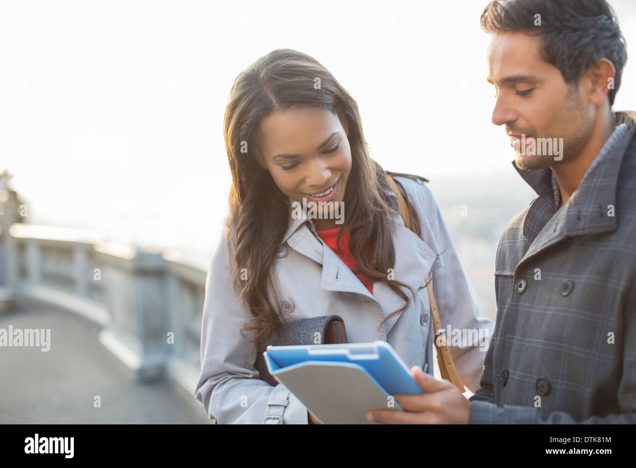 Business people using digital tablet outdoors Banque D'Images