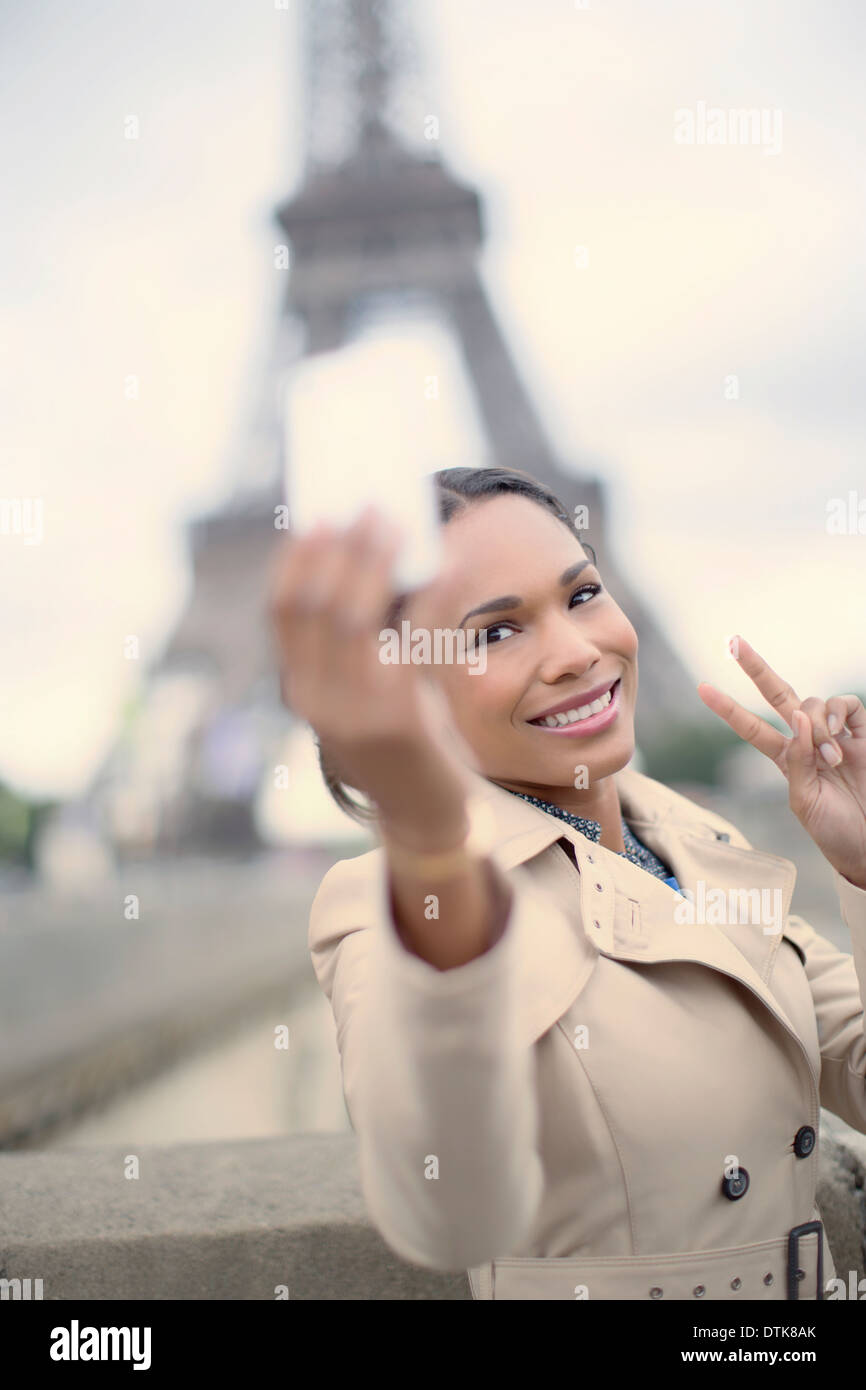 Woman taking photo en face de la Tour Eiffel, Paris, France Banque D'Images