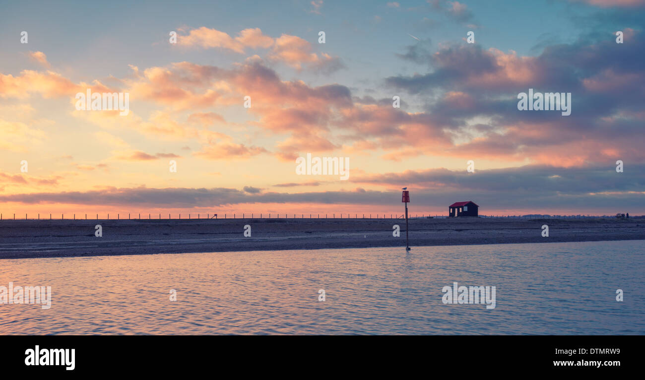 Un beau coucher du soleil à Rye Harbour, à la recherche de Camber Sands. Banque D'Images