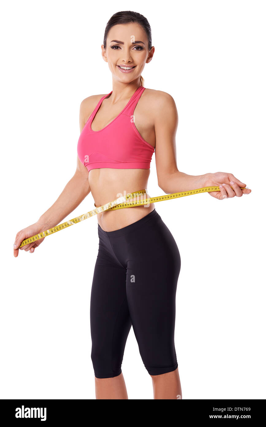 Heureux slim woman measuring her waist Banque D'Images