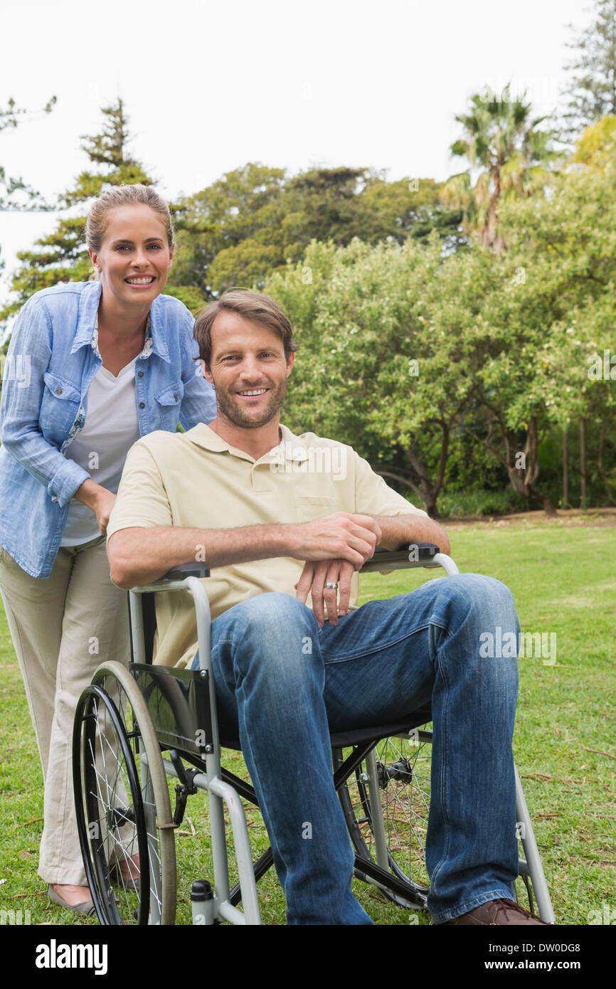 Happy man in wheelchair with partner Banque D'Images