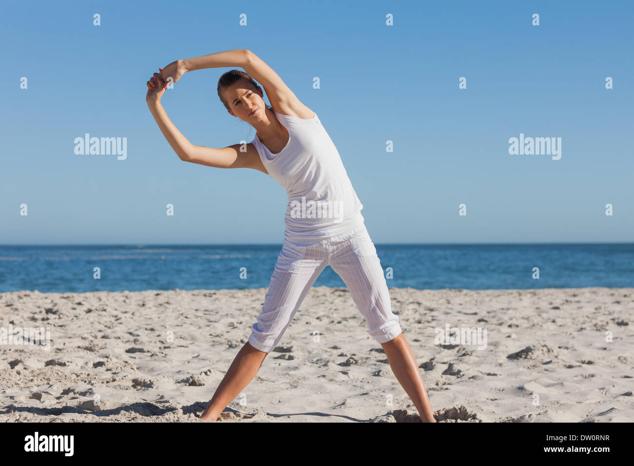 Woman stretching in yoga pose Banque D'Images