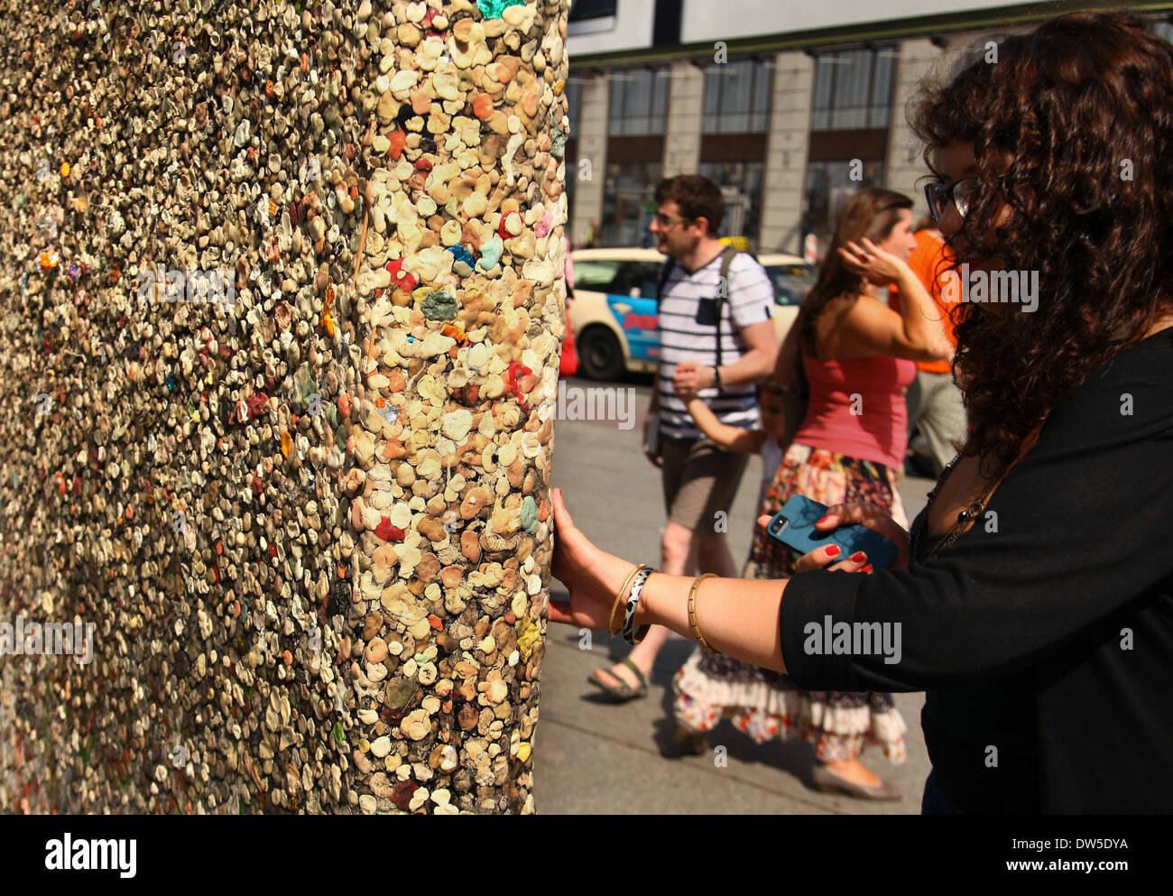 Une femme touche touristique le "mur de gomme' à la Potsdamer Platz à Berlin, le 15 août 2013. De plus en plus de touristes viennent à la capitale allemande chaque année. ATTENTION : Cette photo fait partie d'une série sur le tourisme à Berlin. Photo : Wolfram Steinberg dpa Banque D'Images