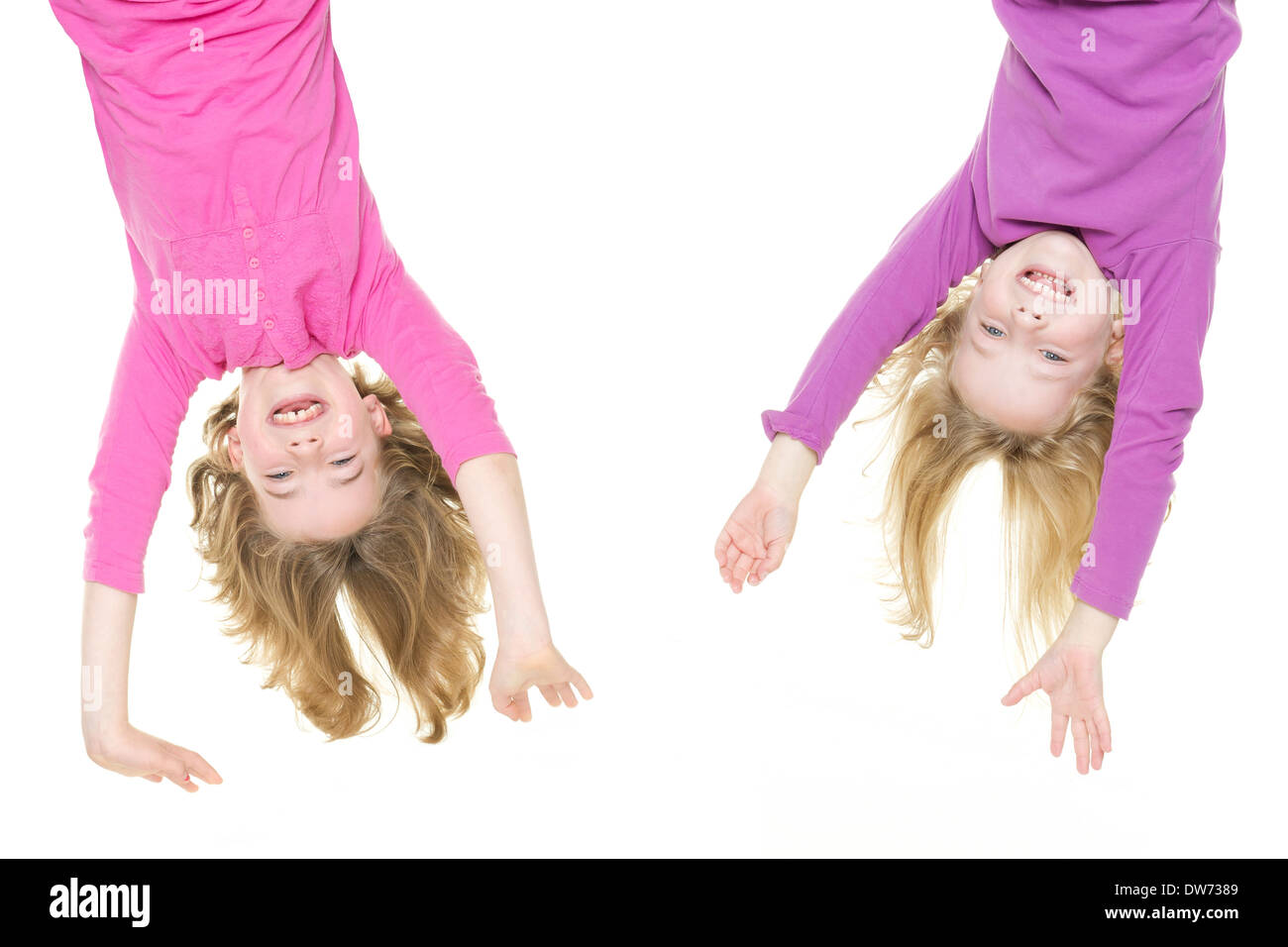 Smiling young girls hanging in front of white background Banque D'Images