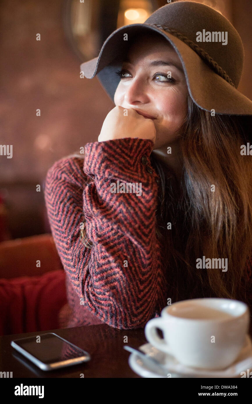 Portrait of young woman wearing hat s'appuyant sur le coude Banque D'Images