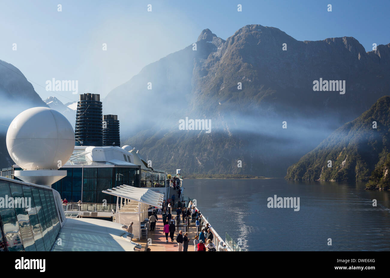 Milford Sound, Nouvelle-Zélande, parc national de Fiordland - passagers sur un bateau de croisière naviguant dans le Sound tôt le matin Banque D'Images