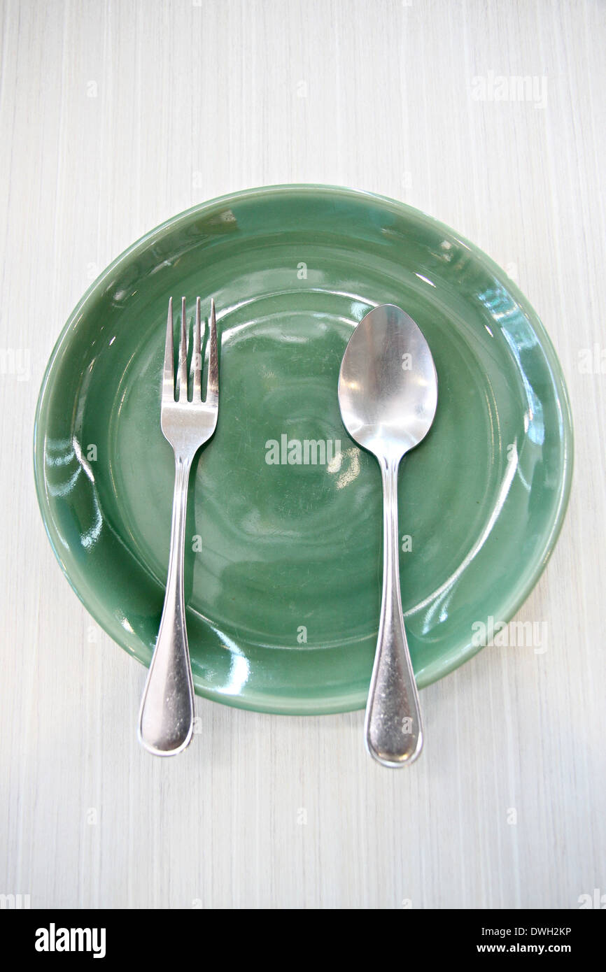 Plat vert et la cuillère sur la table. Banque D'Images