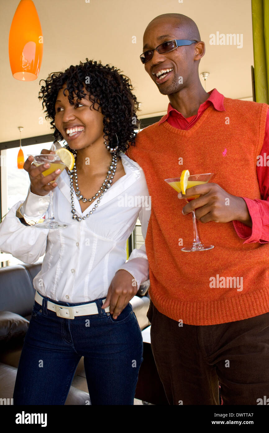 Happy hour dans nouvelle SA. Un jeune couple avec orange martini aime la grande vie. Parution du modèle Banque D'Images