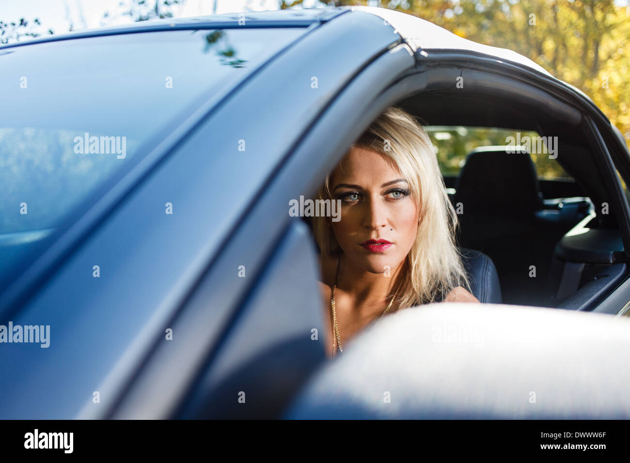 Young blonde woman portrait dans une voiture. Banque D'Images