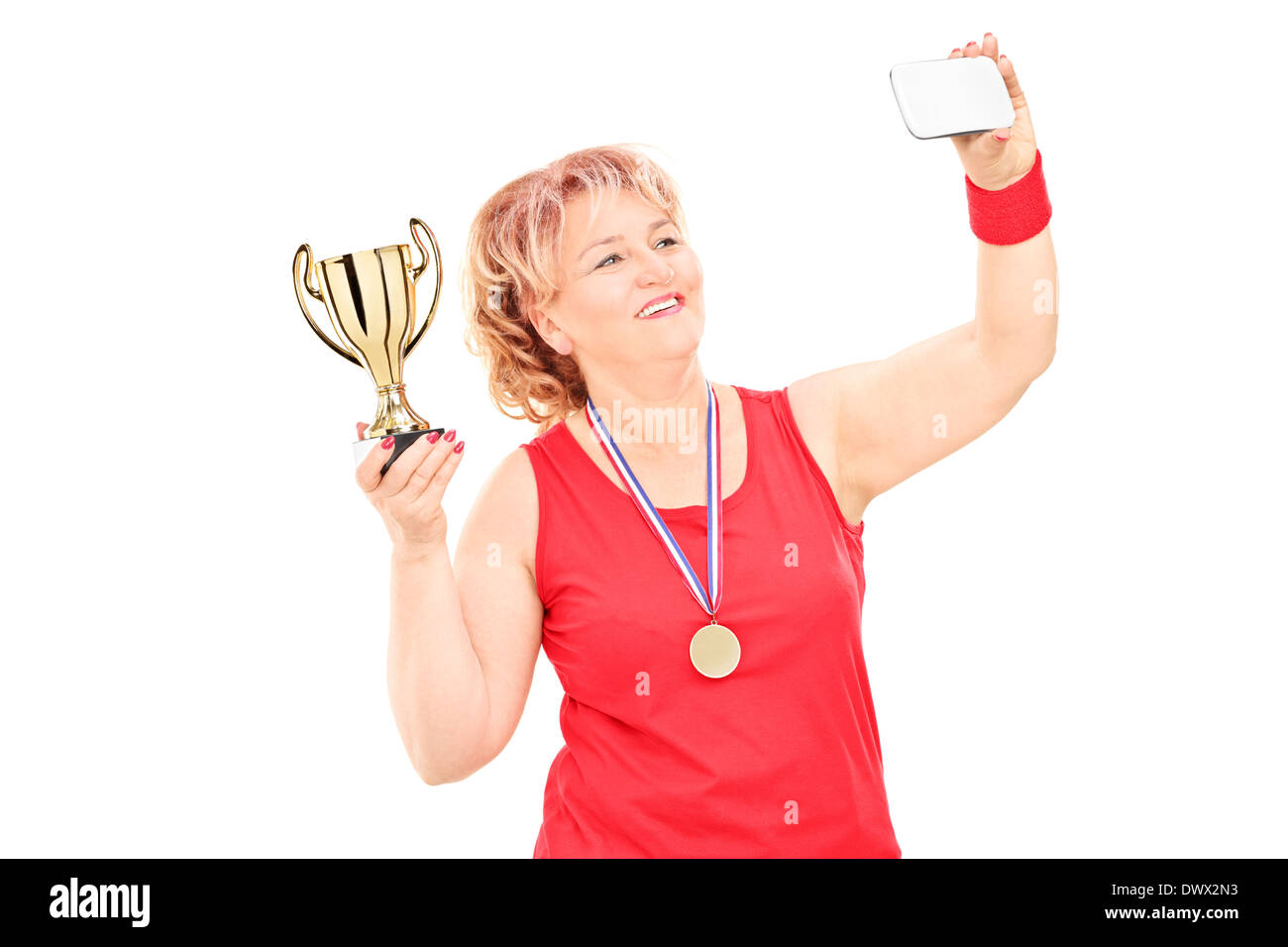 Woman in sportswear holding trophy et en tenant un selfies Banque D'Images