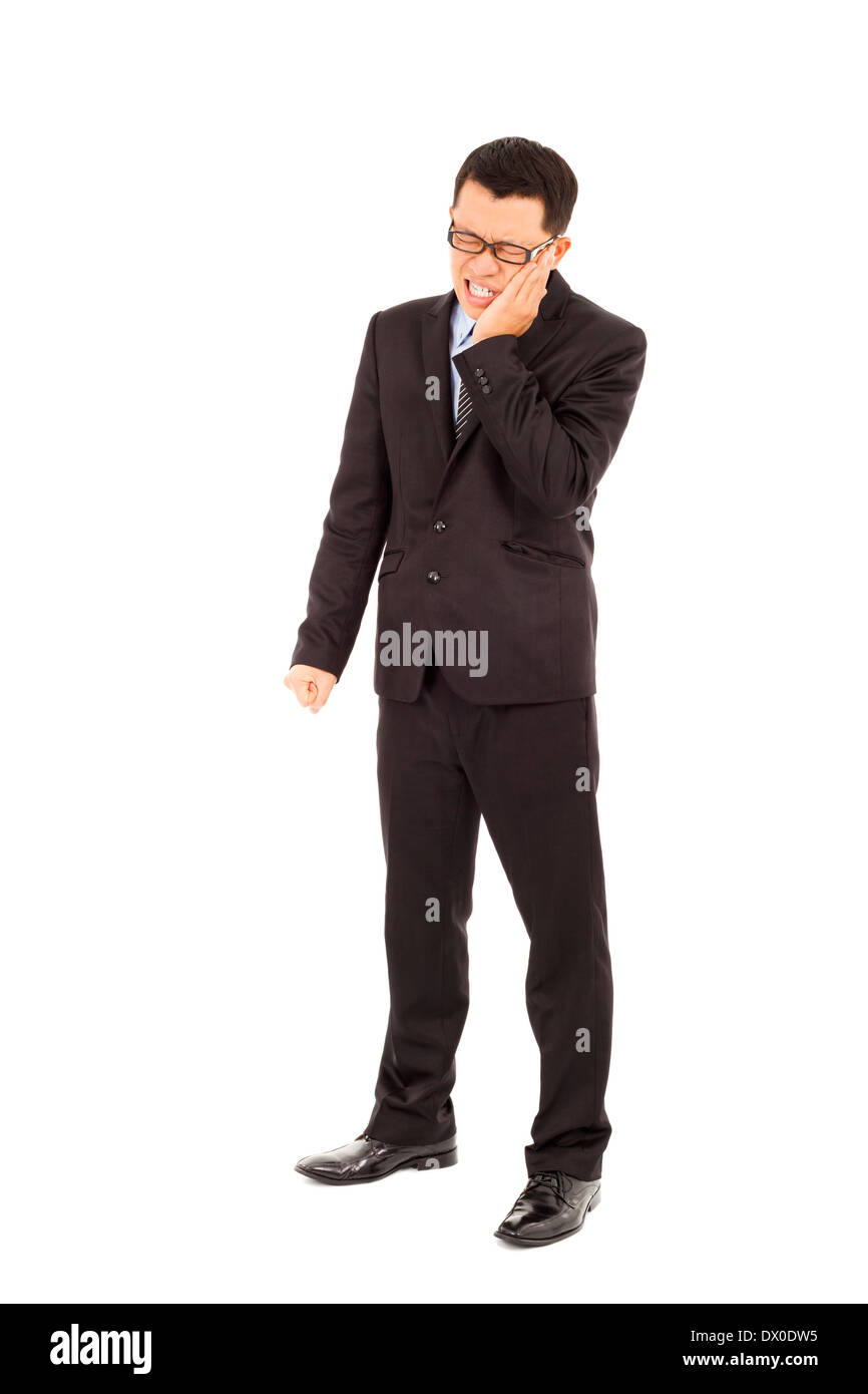 Young businessman standing et à l'agonie avec une rage de dents en studio Banque D'Images
