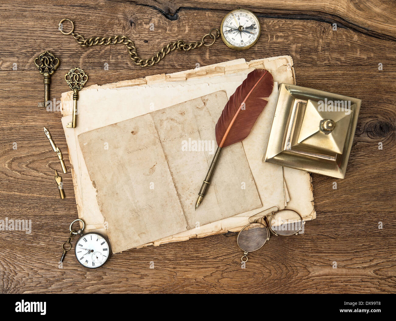 Accessoires anciens et des fournitures de bureau sur fond de table en bois. des sons vintage, horloge, lunettes, stylo plume, boussole. Banque D'Images