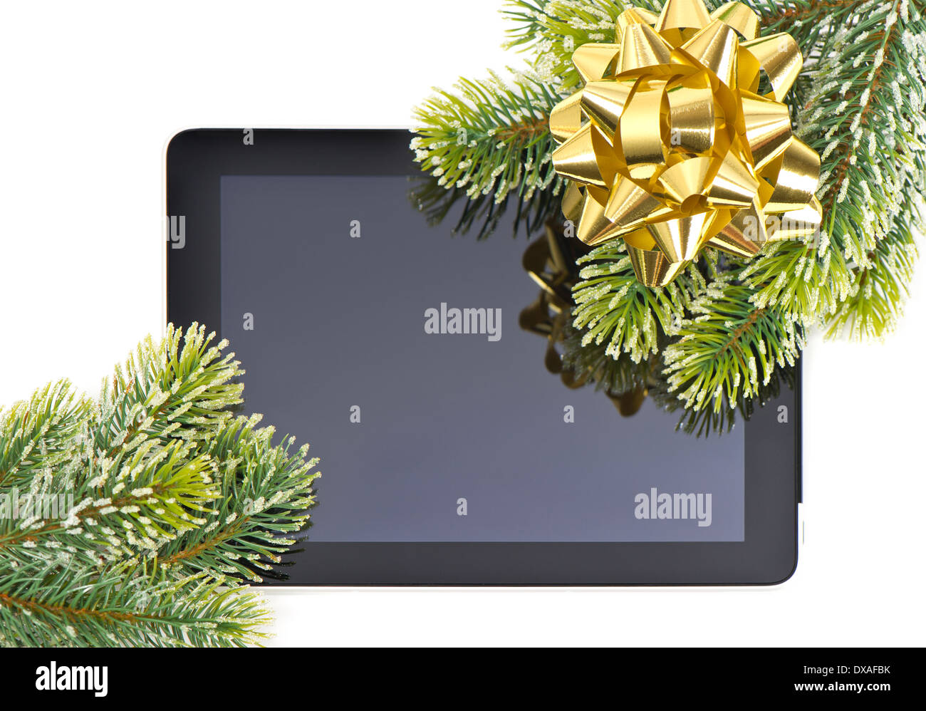 Tablet pc et branche d'arbre avec archet d'or concept cadeau. Banque D'Images