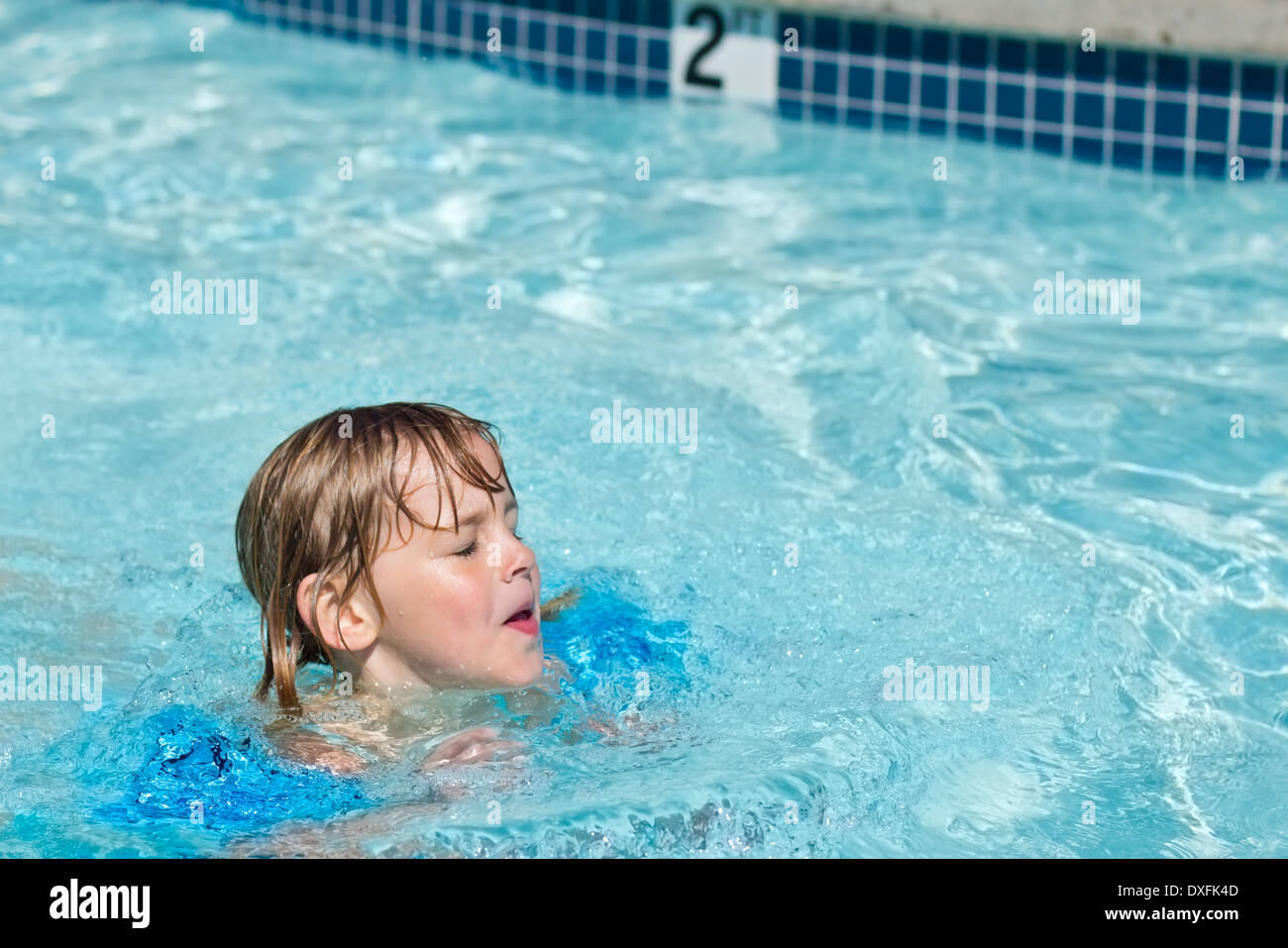 Petite baignade dans la piscine avec ses yeux fermés Banque D'Images