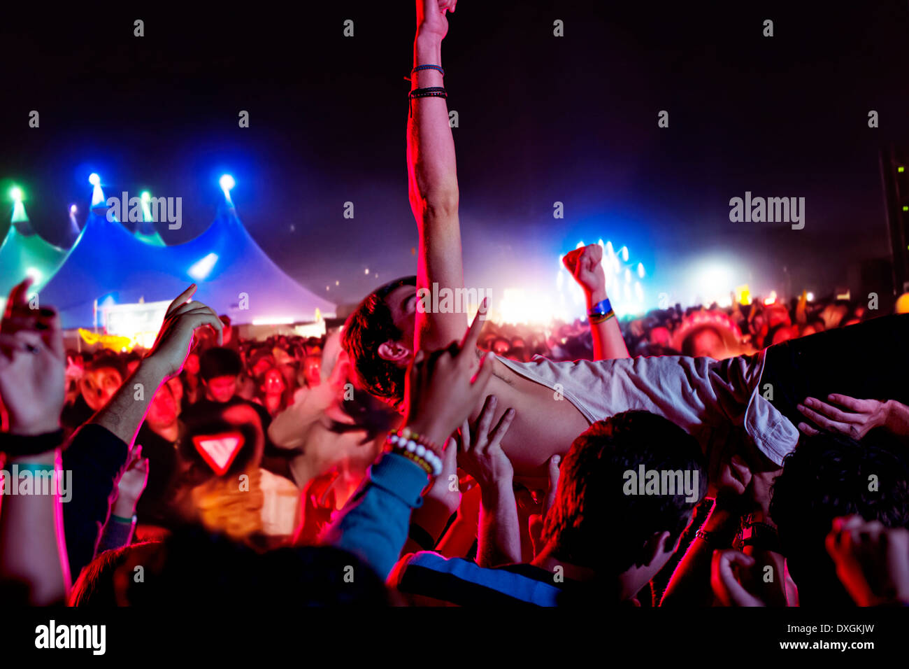 Man crowd surfing at music festival Banque D'Images