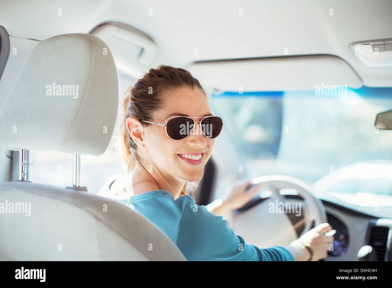 Portrait of woman in sunglasses driving car Banque D'Images