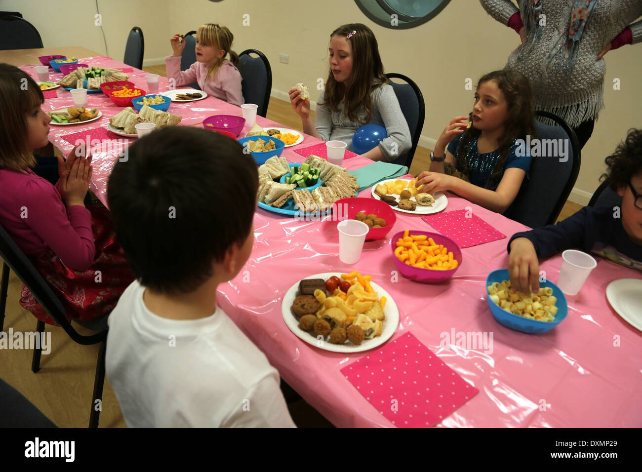 8 Ans Fille D Anniversaire Enfants A La Table De Manger Des Aliments Dorset Angleterre Photo Stock Alamy