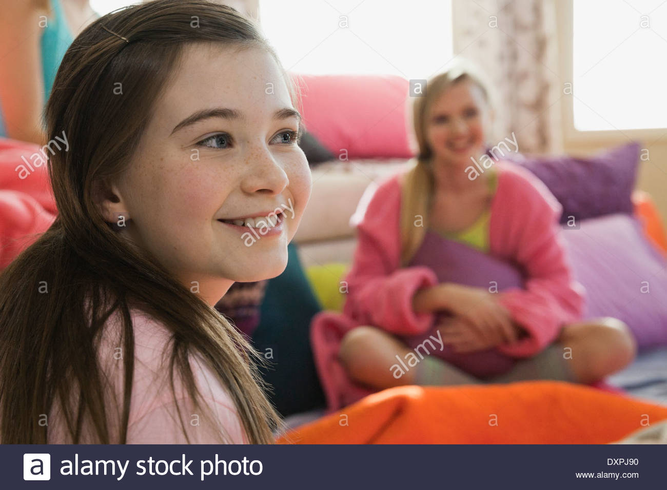 Smiling girl looking at slumber party Banque D'Images