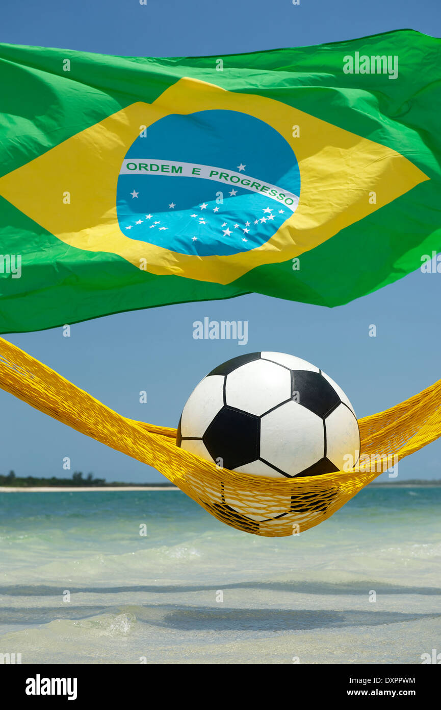 Ballon de soccer de football assez paresseux en relaxant beach hamac avec drapeau brésilien Banque D'Images