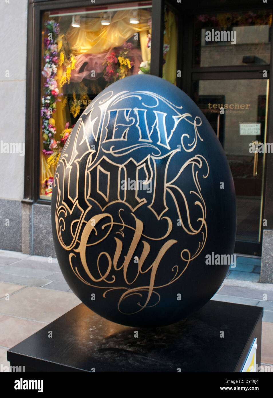 New York, NY - 6 Avril 2014 : Un œuf Fabergé, 'NYC dans Black & Gold', créé par tatoueur Nick Matic, est affichée à Rockefeller Center dans le cadre de la grande chasse aux oeufs Fabergé en avril 1-17 (Egg # 185). Cet oeuf est un des quelque 275 créés par de célèbres designers et affichées tout au long de la ville de New York. Le public est invité à localiser les oeufs avec une application pour smartphone pour une chance de gagner des prix. Produit de la vente des œufs et autres produits aller à la charité. Banque D'Images