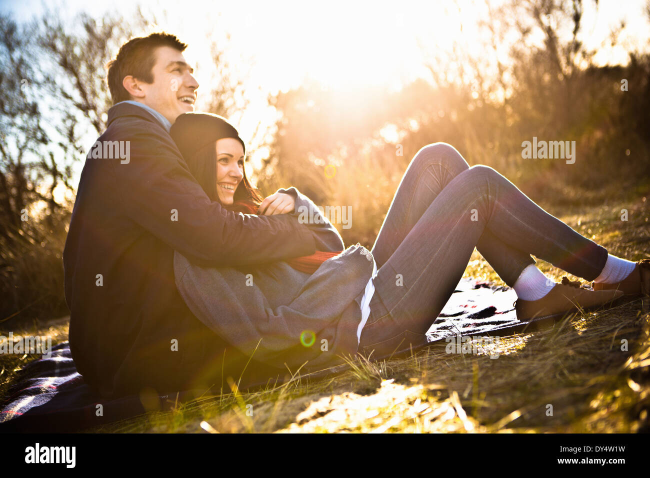 Couple hugging on picnic blanket Banque D'Images