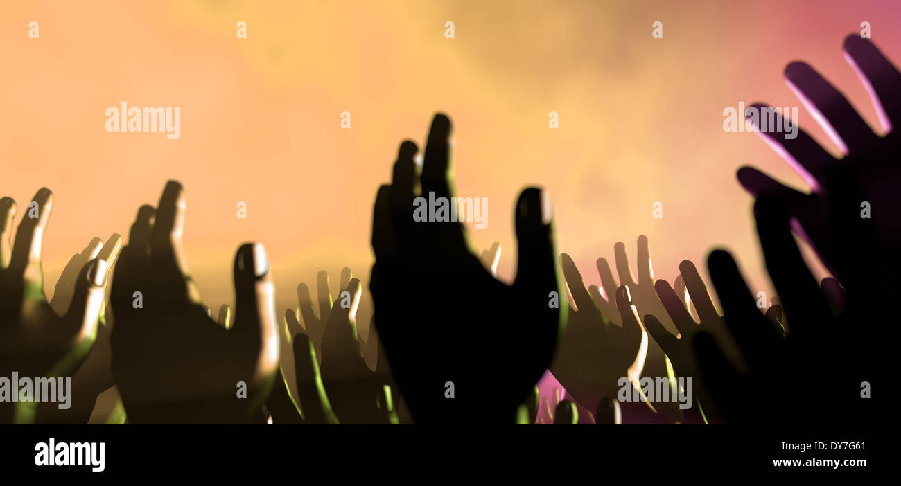 Une foule de mains levées d'affichage au niveau de la foule spectateur entrecoupées de spots colorés et une atmosphère de Smokey Banque D'Images