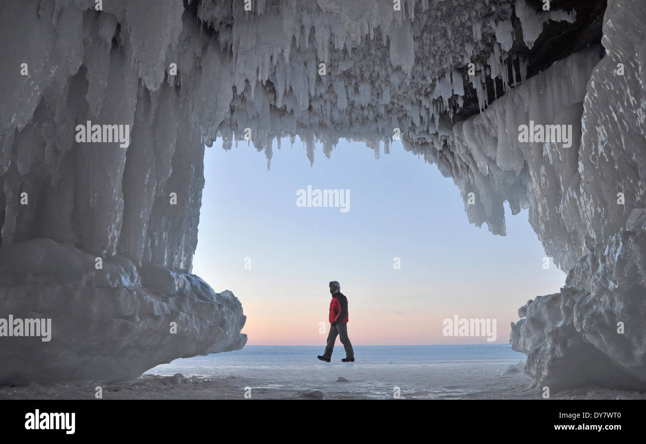 Formations de glace et de glaçons pendant de plafond dans une grotte et un homme marchant sur le lac Supérieur, l'Apôtre Islands National Banque D'Images