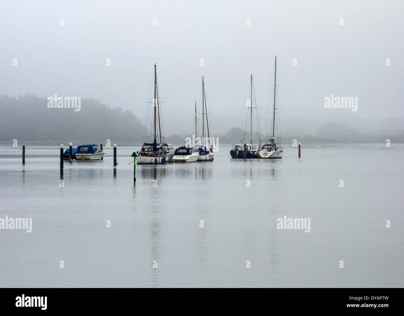 Bateaux amarrés dans le calme sur la rivière conditions brumeuses Yar, île de Wight, Angleterre, RU Banque D'Images