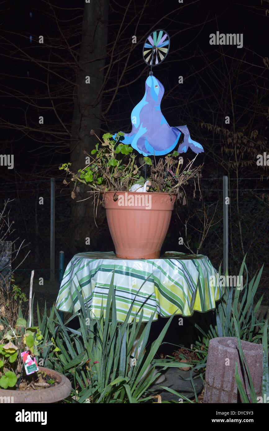 Une scène de nuit un moulin ornement en équilibre sur un nez des joints de la décoration d'une plante en pot, c'est sur un allotissement à Cologne en Allemagne. Banque D'Images